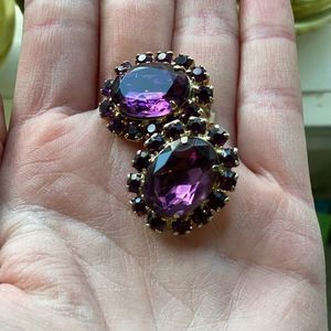 Beautiful vintage purple glass clip earrings. Shown in different lighting